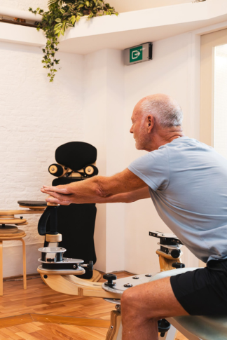 A man performs an exercise using the GYROTONIC method