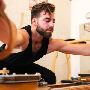 A man is working with GYROTONIC equipment