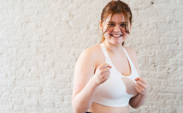 Yoga student holds up two hands